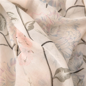 Detailed macro view of soft cotton linen fabric with floral prints and delicate textures
