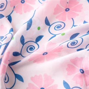 Close-up of pink floral print on soft cotton linen fabric showing fine twill texture