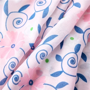 Macro detail of linen cotton scarf with pink gardenia print and soft woven texture