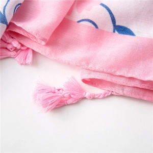 Close-up of pink gardenia pattern scarf with delicate handmade fringe tassels