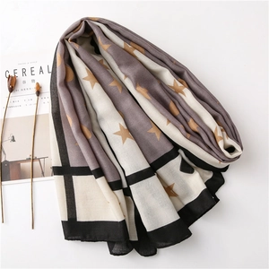 Minimalist winter scarf with star and check pattern on white background with dried flowers