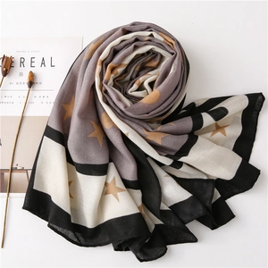 Detailed overhead view of soft cotton-linen scarf with star prints and stripe borders
