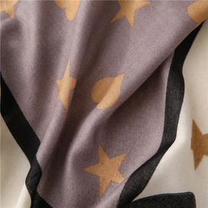 Close-up of soft fabric texture showing star and heart prints with elegant draping folds