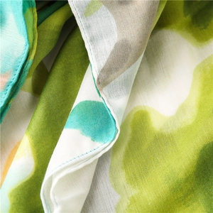 Detail shot of pink and green abstract ink print on lightweight cotton linen scarf texture