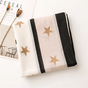 Detail of soft scarf featuring classic stripes and star patterns with fabric texture