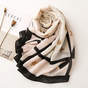 Detail of star pattern scarf with elegant wide black border and Cereal magazine style