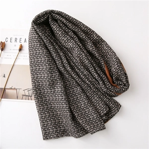 Long geometric pattern knit scarf with double-sided black and caramel brown colors