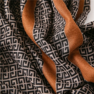 Macro shot of geometric interlocking pattern on soft coffee and gray long scarf