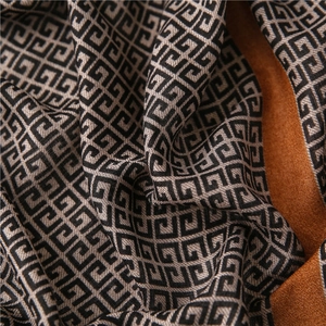 Detailed close-up of geometric pattern scarf with soft texture and refined weave texture