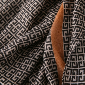 Detailed macro shot of geometric pattern and fine fabric texture on a long scarf