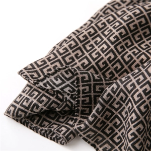Macro shot of geometric pattern on long scarf with fine stitching and soft fabric texture
