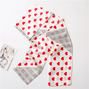 Long silk scarf featuring red heart print and classic black and white houndstooth pattern