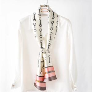 Elegant narrow silk scarf with horse-bit print and pink color-block on white shirt