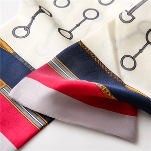 Detail of silk scarf with equestrian horsebit print and smooth glossy texture