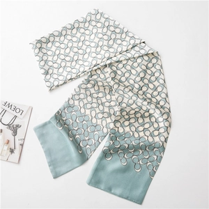 Mint green and white silk scarf featuring a repetitive C-pattern for women’s fashion