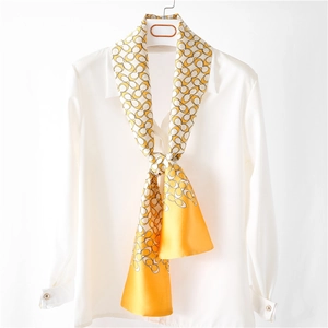 Elegant yellow and white chain pattern silk scarf styled on a white collared shirt