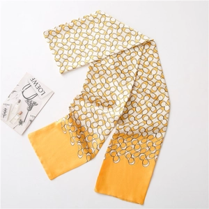 Close-up of a printed silk scarf with classic interconnected patterns and orange tips