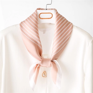 Pink silk neckerchief with white diagonal stripes tied on a classic white shirt collar