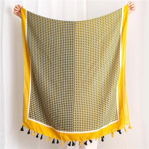 Linen feel scarf with black and white diamond patterns and yellow fringe edges