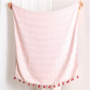 Detail of pink houndstooth cotton linen scarf with soft fringe tassels and woven texture