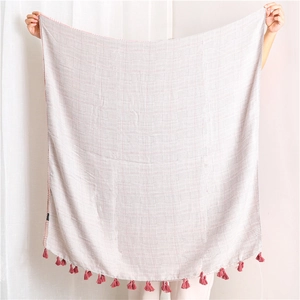 Close-up of cotton linen houndstooth scarf with elegant purple fringe tassels