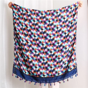 Detail of colorful geometric plaid cotton linen scarf with woven tassel fringe edge