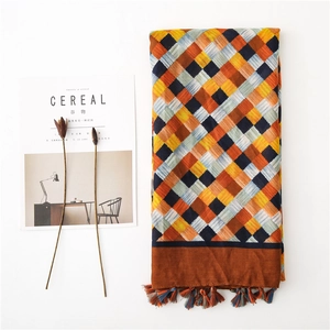 Detailed view of plaid cotton linen scarf with colorful fringe on white background