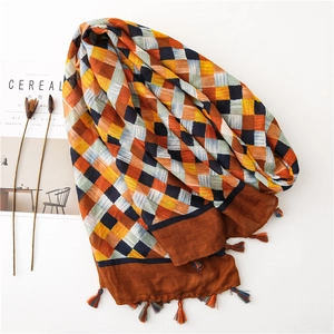 Detail of artistic diamond pattern cotton linen scarf with colorful twisted fringe tassels