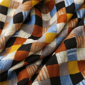Close-up of woven cotton linen scarf fabric with colorful plaid patterns and soft texture