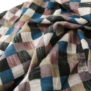 Detailed macro view showing the textured woven cotton-linen fabric and multi-color plaid patterns