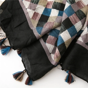 Detailed view of plaid cotton linen scarf with herringbone weave and colorful tassels