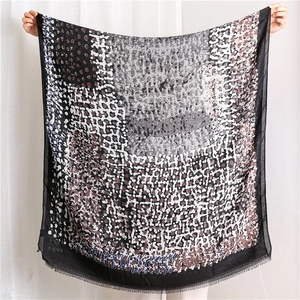 Close-up of linen blend scarf with abstract oil painting print and fine fringe detail