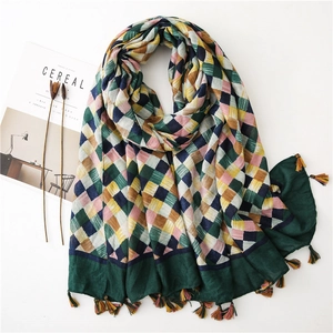 Detail of colorful plaid cotton linen scarf with soft fringes on white background