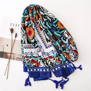 Bohemian floral scarf with royal blue tassels shown in a flat lay minimalist setup
