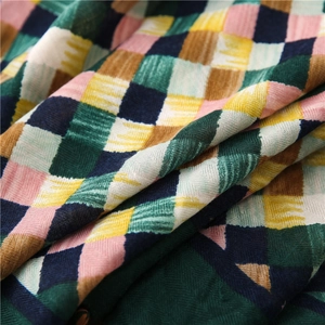 Macro view of colorful checkered scarf fabric with detailed herringbone weave texture