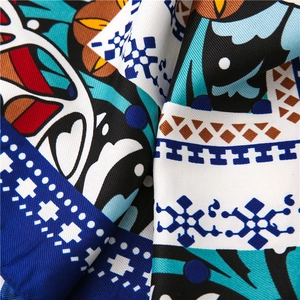 Close-up of twill silk scarf featuring bohemian snowflake and geometric patterns