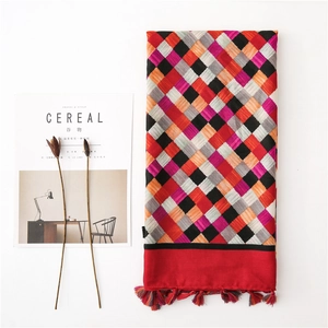 Detail of colorful plaid cotton linen scarf featuring vibrant fringe and woven patterns
