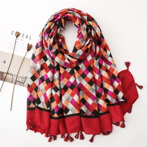 Detail of checkered cotton linen scarf featuring colorful tassels and fringe edges
