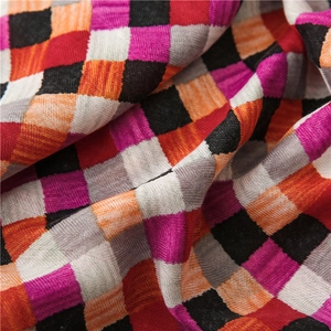 Close-up of woven cotton-linen scarf showing multi-color plaid texture and soft fabric