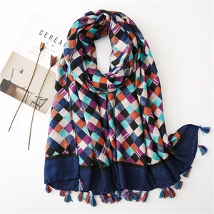 Detail of plaid cotton linen scarf with geometric checkerboard pattern and fringe