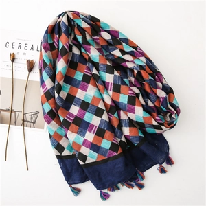Detail of colorful woven check scarf featuring boho tassels and soft cotton linen texture