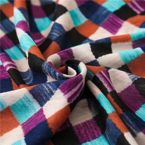 Detailed close-up of woven cotton linen scarf fabric with colorful grid pattern and texture