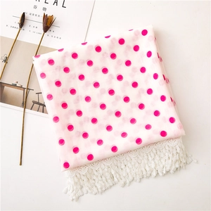 Detail of white semi-transparent scarf featuring pink polka dots and hollow lace trim