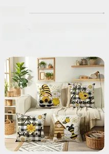 Set of four bee-themed throw pillow covers featuring Bee Kind text on a cozy white sofa