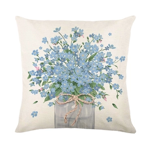 Blue floral polyester pillow cover featuring forget-me-nots in a glass jar on white background