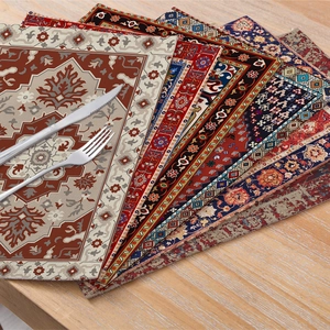 Bohemian linen placemats with vintage patterns stacked on a wooden dining table