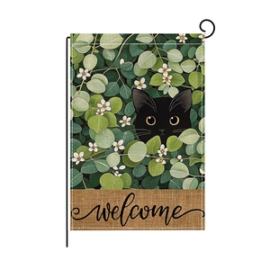 Garden flag with black cat and green foliage featuring a welcome message and metal stand