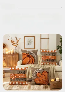 Close-up of four autumn pillow covers with pumpkin prints and fall phrases on a white sofa