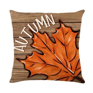 Autumn throw pillow case with orange maple leaves and white text on wood background