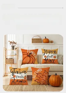 Detail of four fall cushion covers with pumpkin and maple leaf prints on linen texture